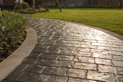 Stamped concrete effect to look like stone on a pathway in a yard
